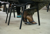 The feet of a man waiting at the migrant transit centre in Danli, Honduras