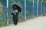Rohingya woman carrying her baby in the Rohingya camp.