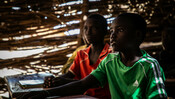 Ismael and Abdoul sitting in their classroom