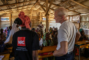 Jan Egeland and an NRC staff in a classroom